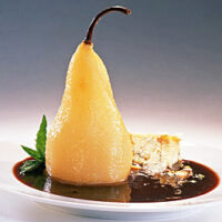 Poached Pear with Stilton Cheese, Pistachio Nuts, and Sun Dried Cherry Sauce